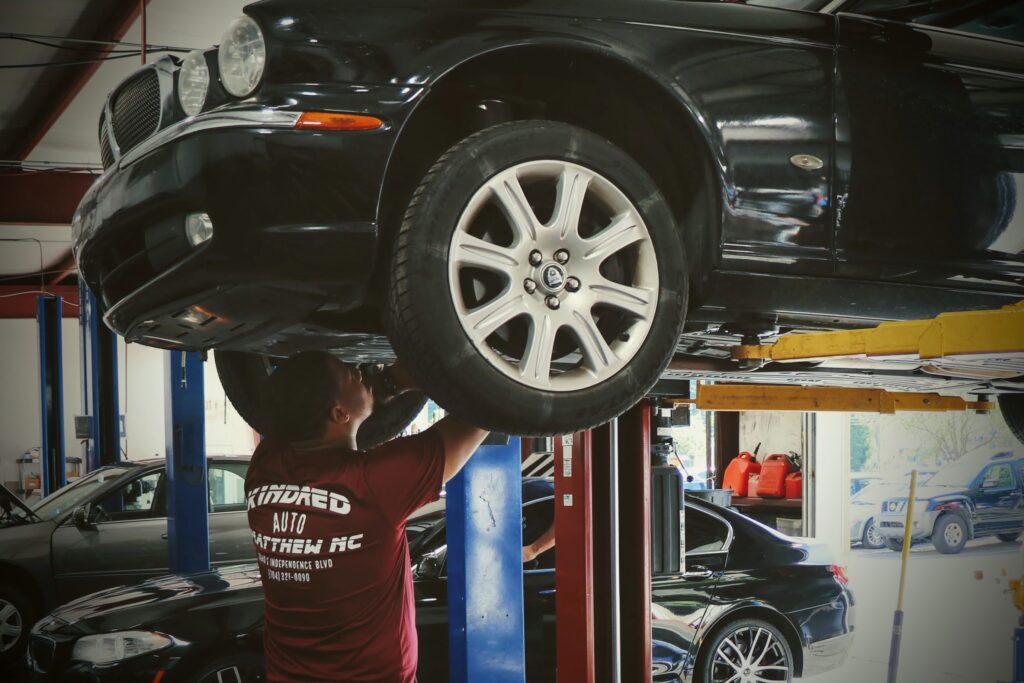 kindred automotive employee working on car that is in for service